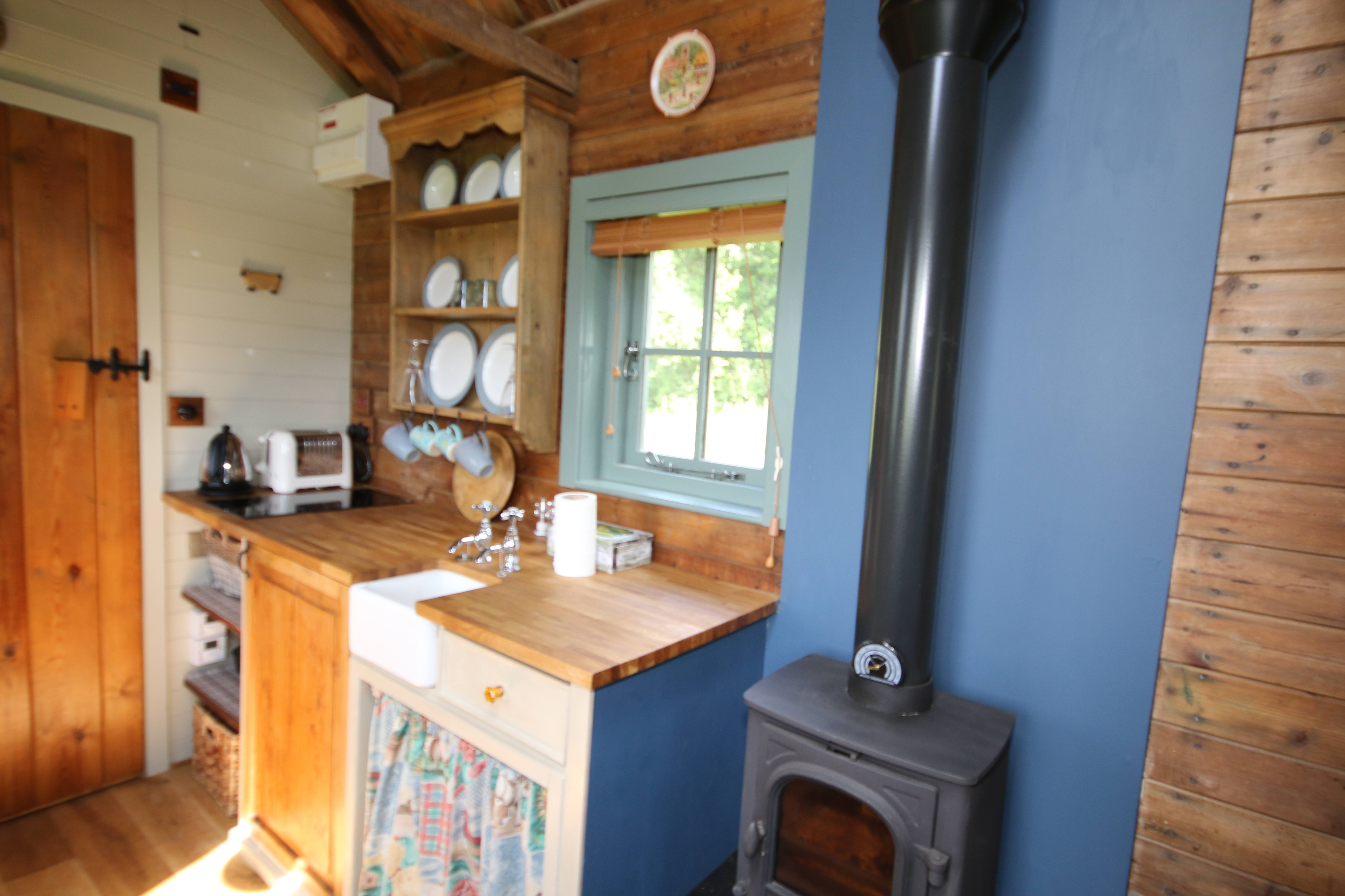 Kitchen area and woodstove at our Shepherds hut |Greenhill Glamping
